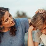 madre che consola figlio triste